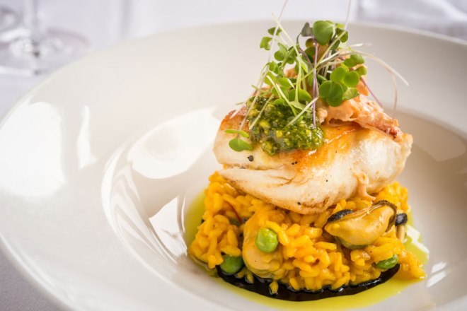 PEI Halibut a la Plancha on an Applewood Smoked PEI Mussel, Seasonal Vegetable, and Saffron Risotto with Belle River Rock Crab Rouille and Arugula-Pistachio Pesto / Chef Chris Colburn, Dalvay by the Sea